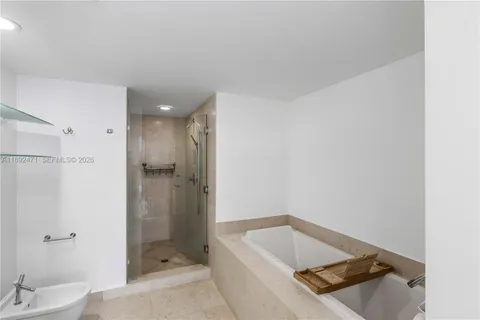 a bathroom with a tub a toilet and sink