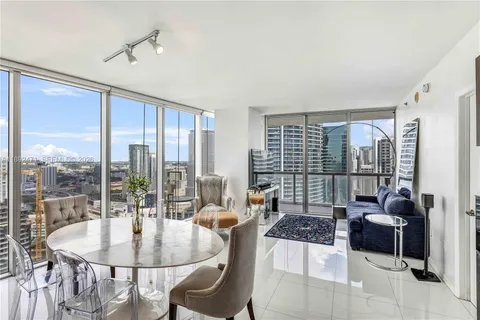 a living room with furniture and a floor to ceiling window