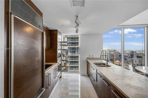 a kitchen with stainless steel appliances granite countertop a sink and stove