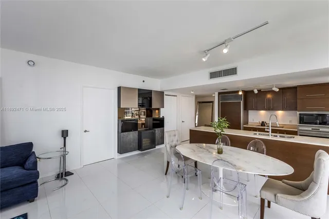 a kitchen with stainless steel appliances kitchen island granite countertop a sink and cabinets