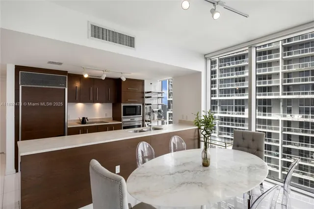 a large kitchen with a table and chairs in it
