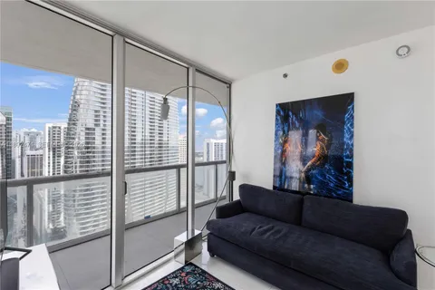 a living room with furniture and a glass door