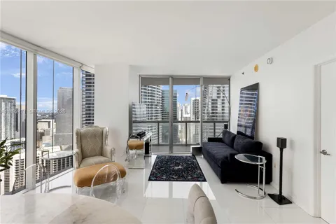 a living room with furniture and a floor to ceiling window