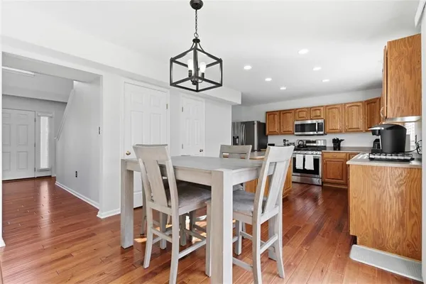 a view of a dining room with furniture a kitchen and chandelier