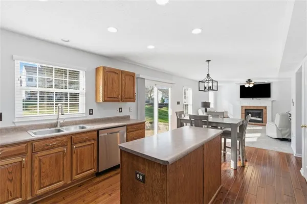 a kitchen with sink stove microwave and cabinets