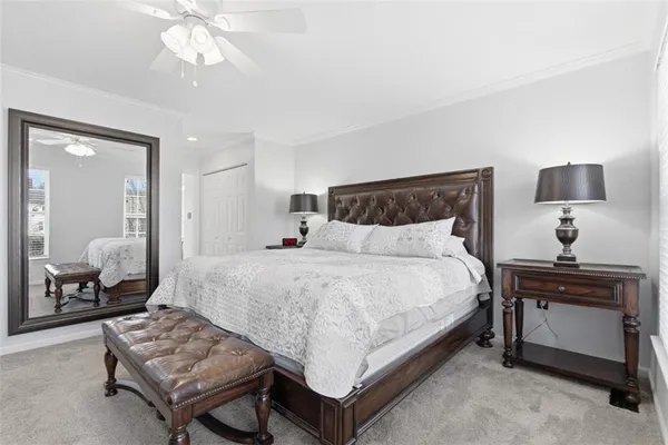 a spacious bedroom with a bed and a chandelier