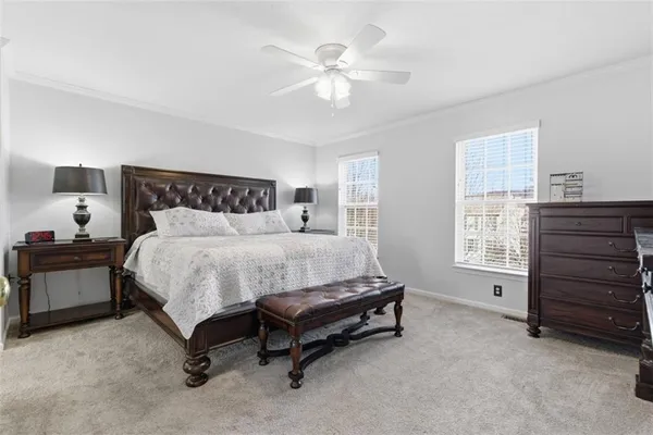 a bed sitting in a bedroom and couch