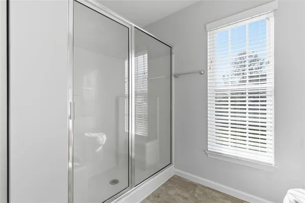 a bathroom with a glass shower door
