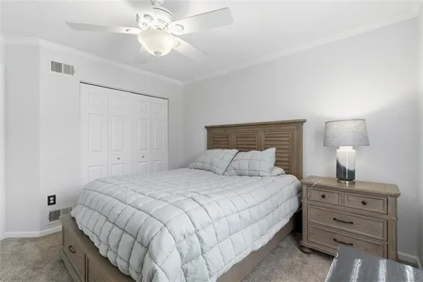 a bedroom with a bed and a lamp