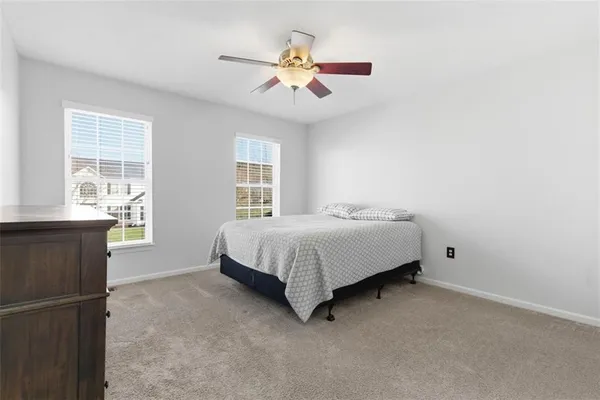 a spacious bedroom with a bed and a window