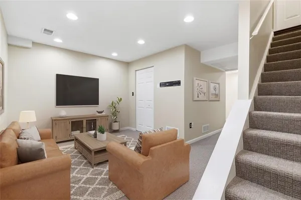 a living room with furniture and a flat screen tv