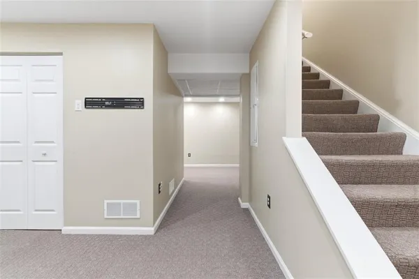 a view of a hallway with staircase