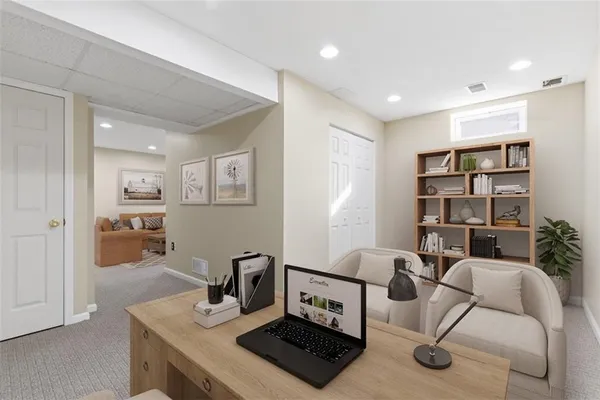 a living room with furniture and a book shelf