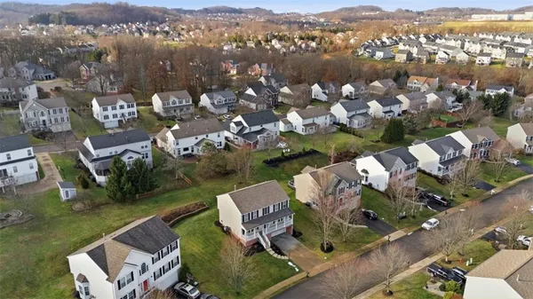 an aerial view of lake and residential houses with outdoor space