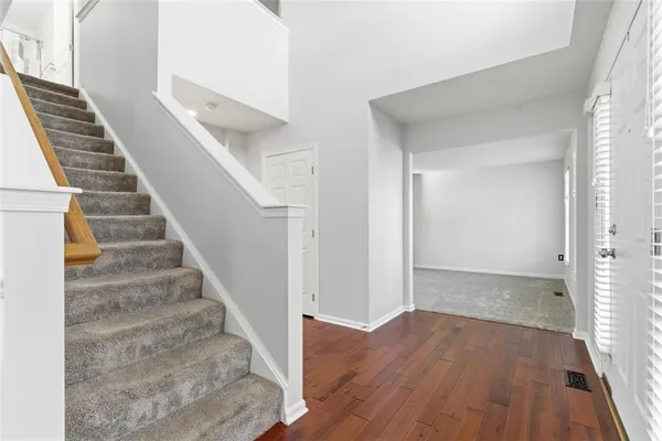 a view of an entryway with wooden floor
