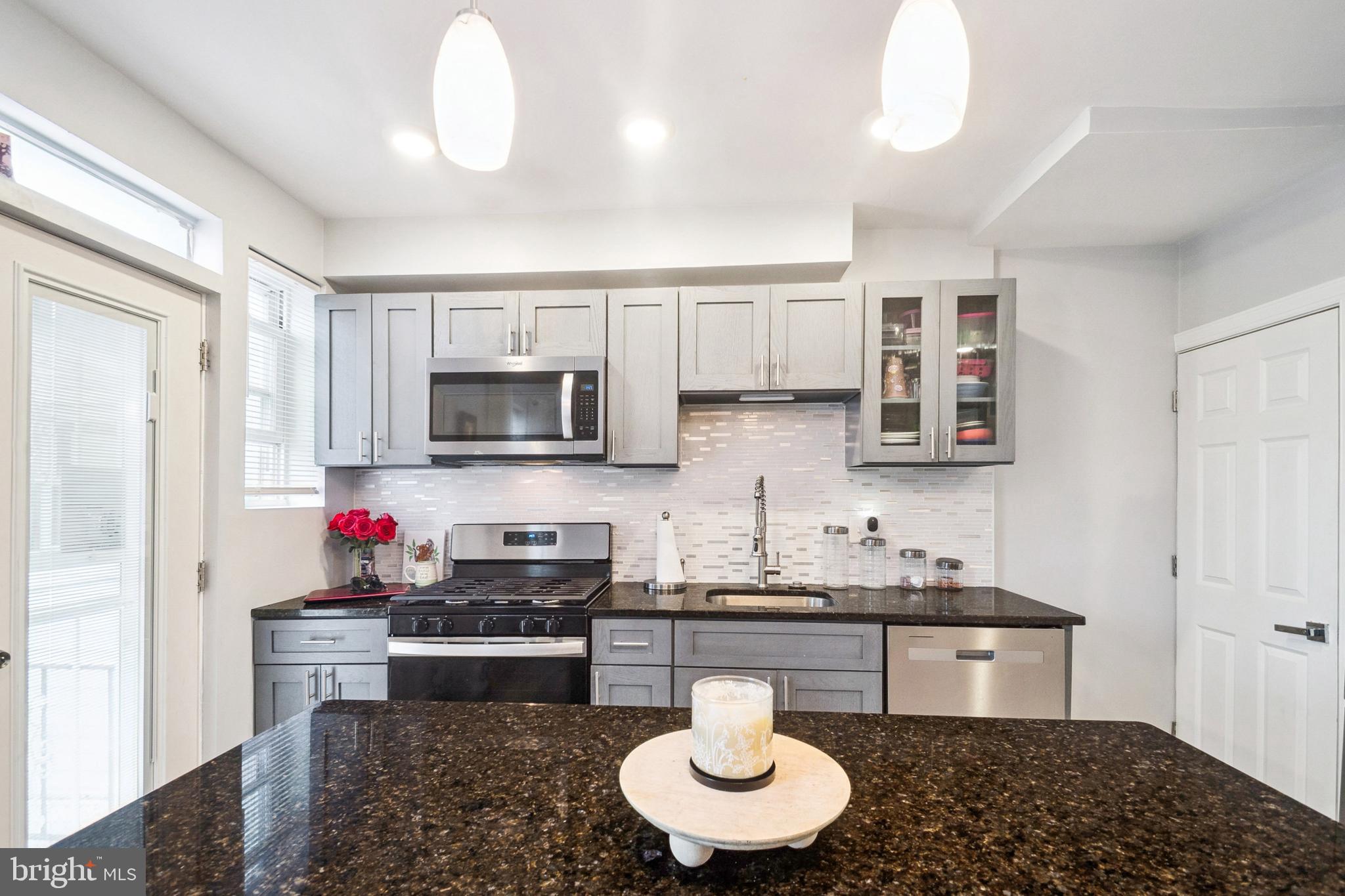 3404 Lyndale Avenue Baltimore, MD 21213 - Photo 12 of 25 a kitchen with stainless steel appliances a stove a sink and a microwave