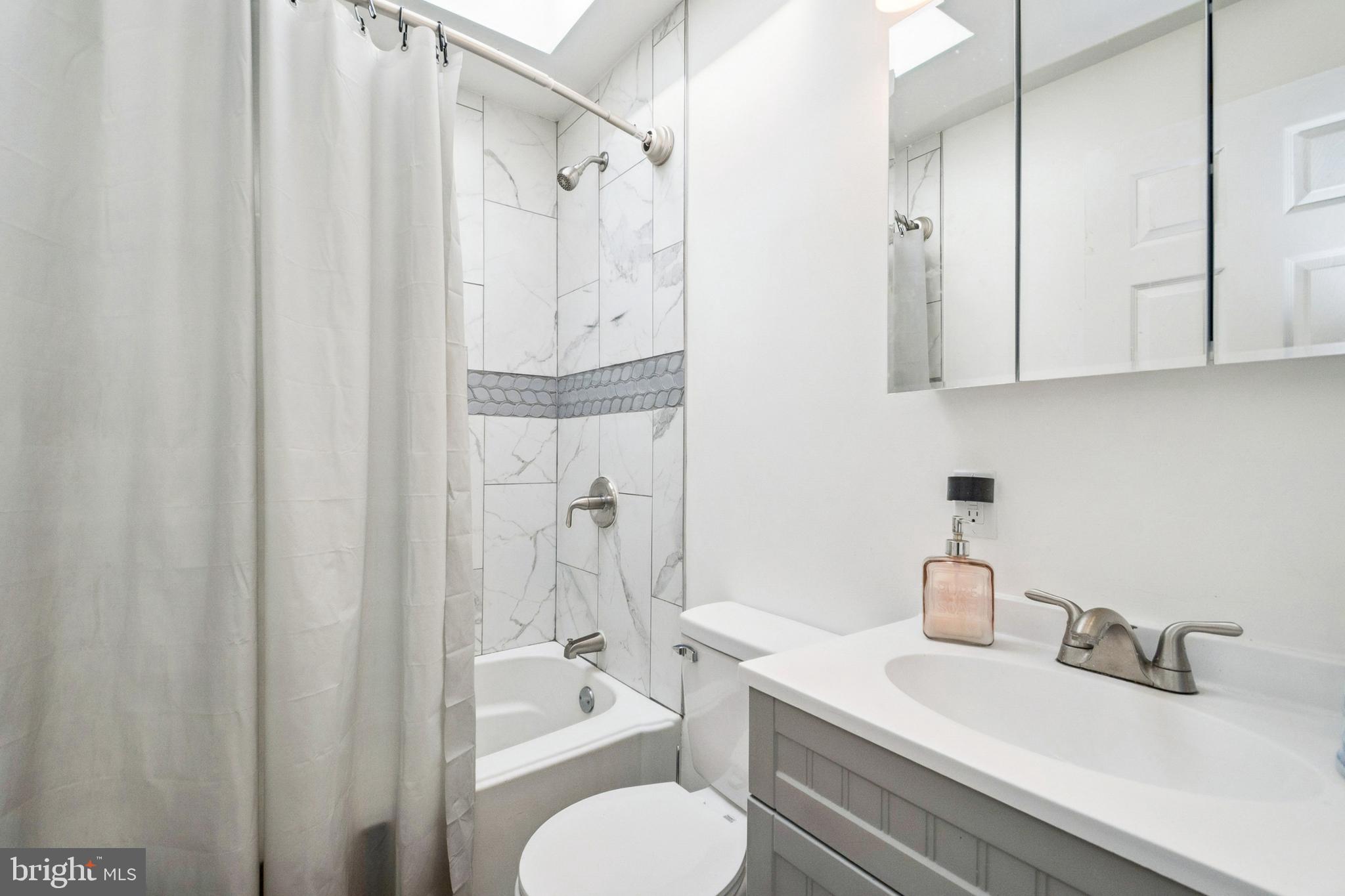 3404 Lyndale Avenue Baltimore, MD 21213 - Photo 17 of 25 a bathroom with a granite countertop sink toilet and shower