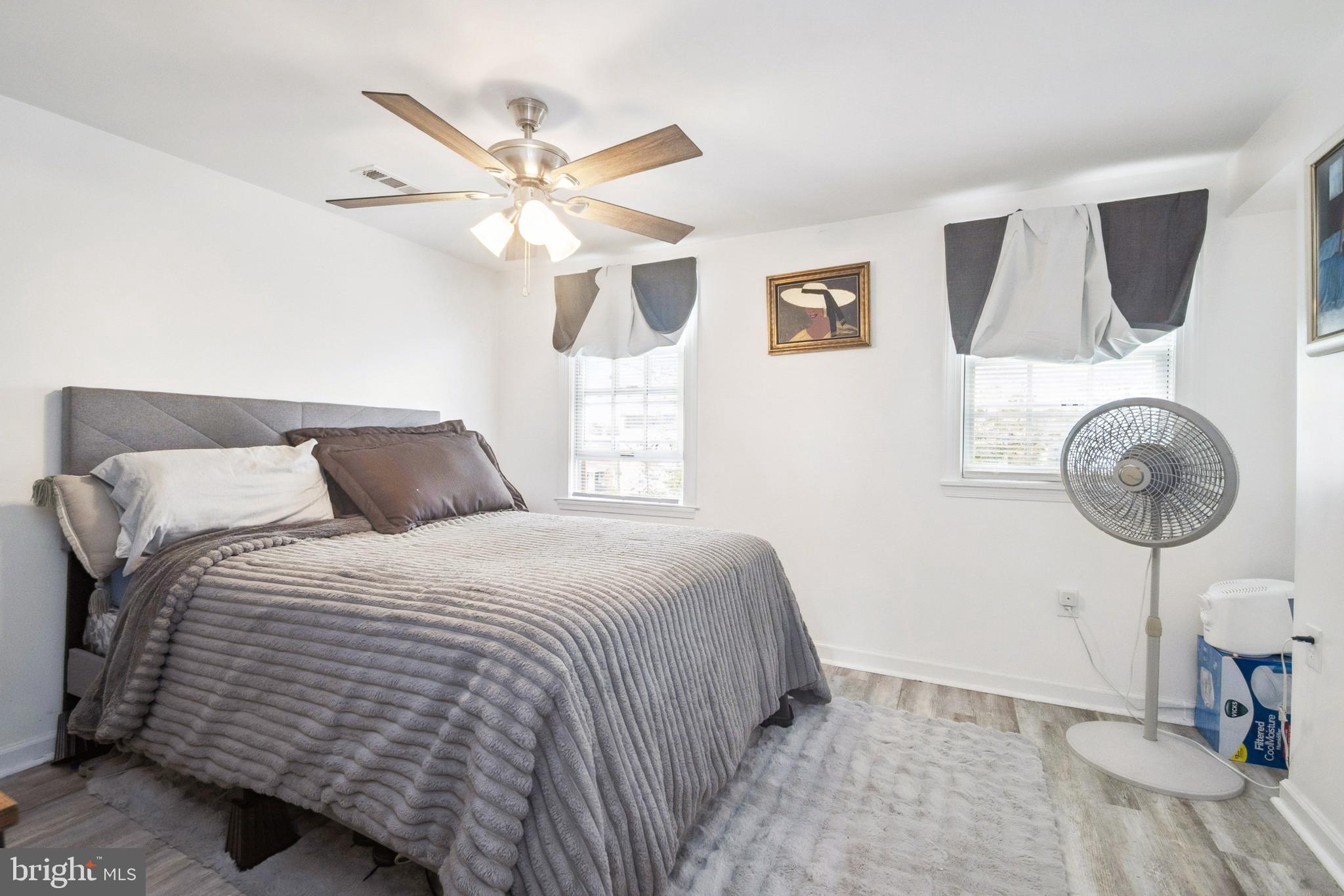 3404 Lyndale Avenue Baltimore, MD 21213 - Photo 18 of 25 a bedroom with a bed and a chandelier