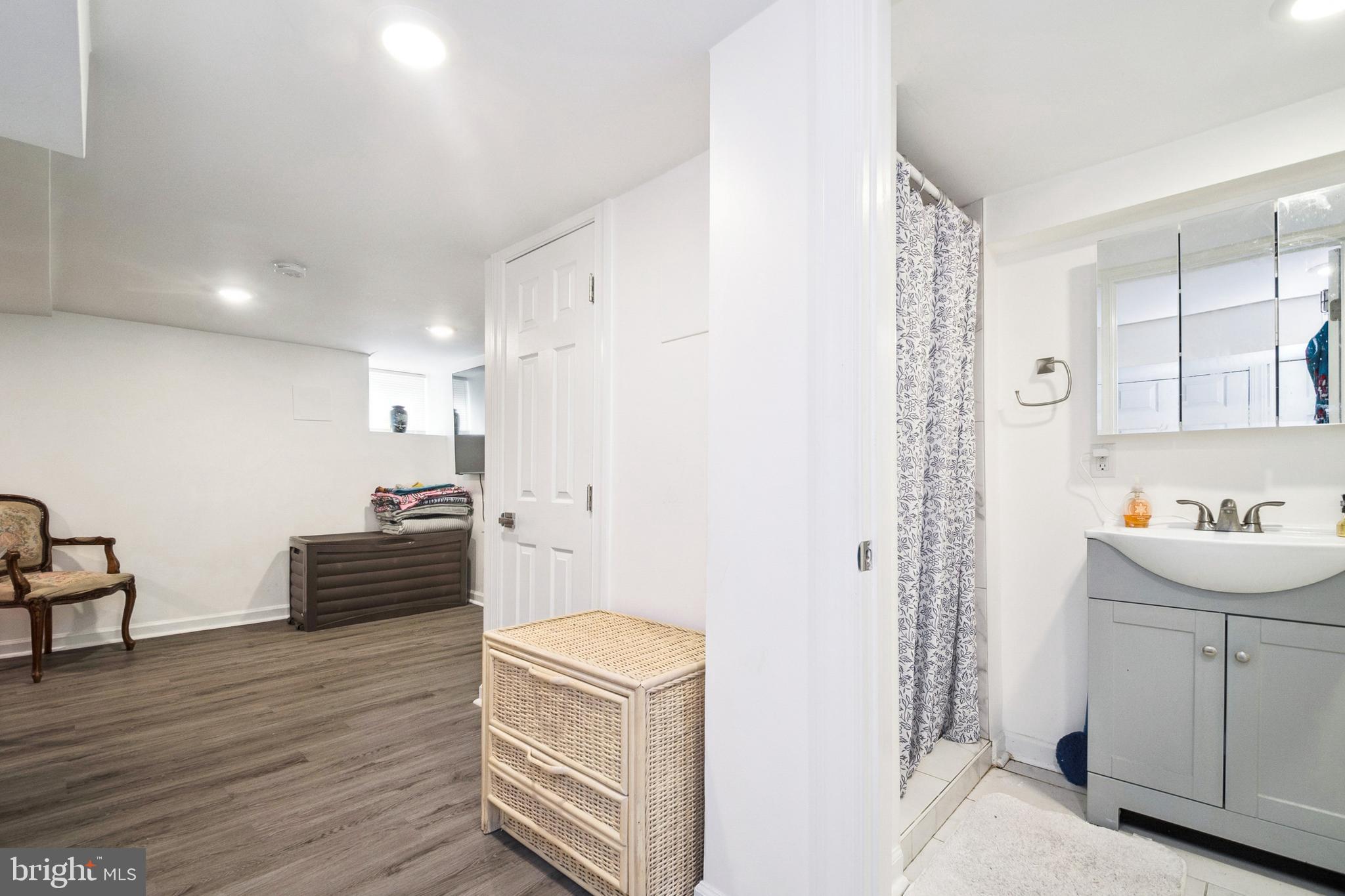3404 Lyndale Avenue Baltimore, MD 21213 - Photo 20 of 25 a room with furniture a wooden floor and a sink