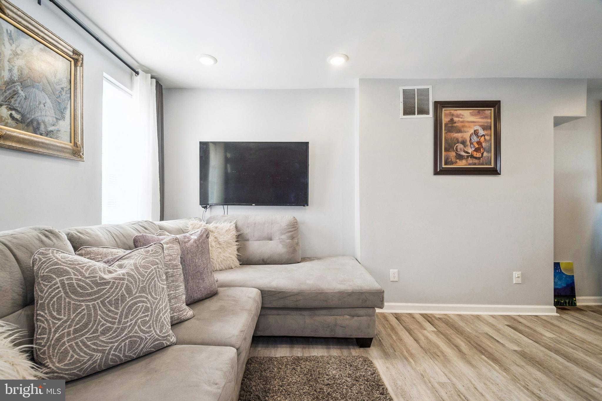 3404 Lyndale Avenue Baltimore, MD 21213 - Photo 2 of 25 a living room with furniture and a flat screen tv