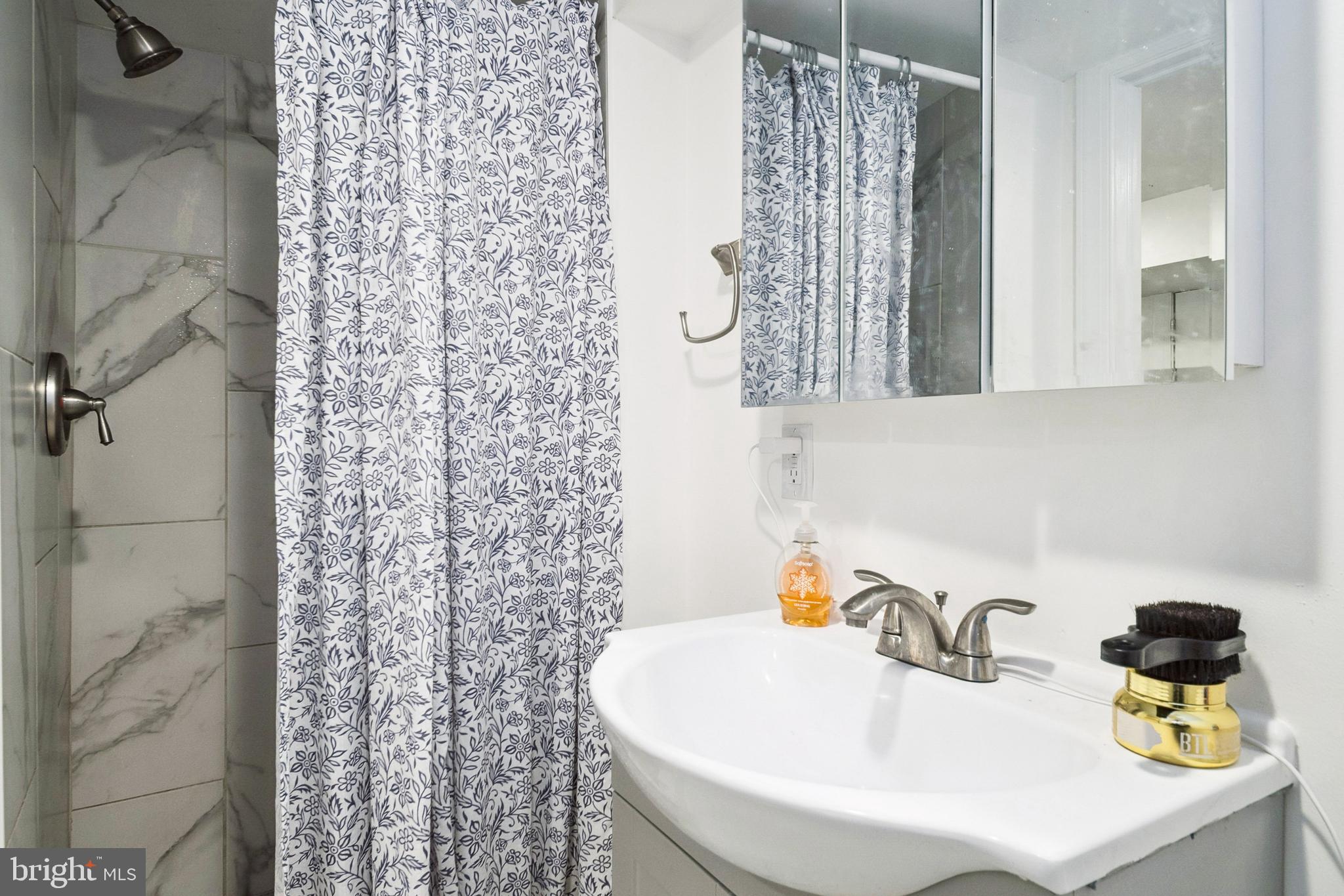 3404 Lyndale Avenue Baltimore, MD 21213 - Photo 21 of 25 a bathroom with a sink and a mirror