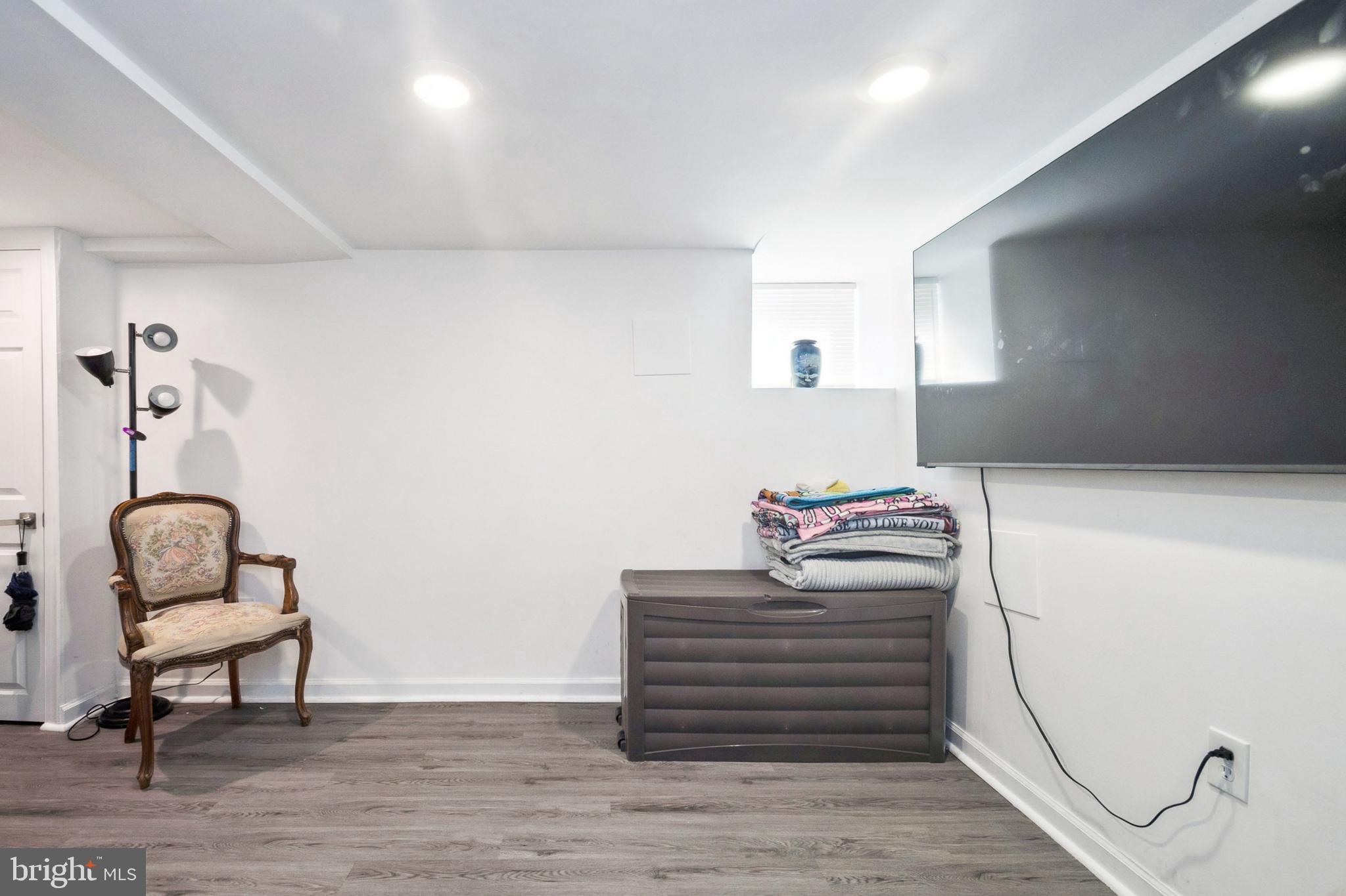 3404 Lyndale Avenue Baltimore, MD 21213 - Photo 23 of 25 a bedroom with a bed and a chair