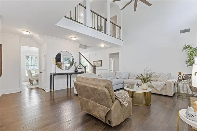a kitchen with stainless steel appliances kitchen island granite countertop a table chairs and white cabinets