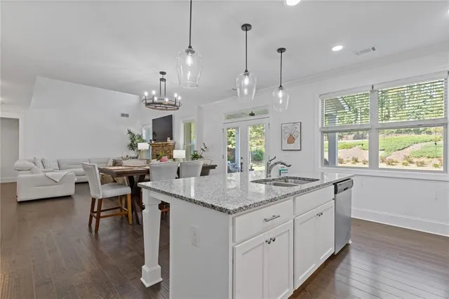 a bathroom with a granite countertop sink vanity mirror and toilet