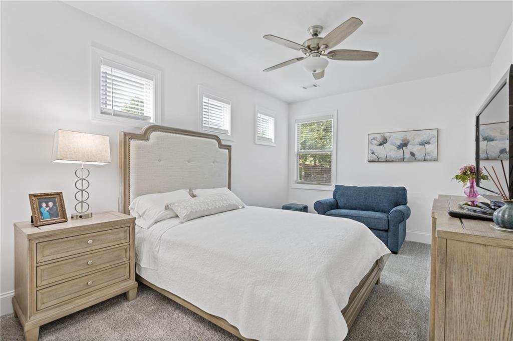 4867 Hunters Grove Way Sugar Hill, GA 30518 - Photo 25 of 61 a bedroom with a bed and furniture