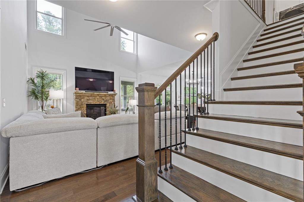 4867 Hunters Grove Way Sugar Hill, GA 30518 - Photo 28 of 61 a living room with furniture a fireplace and a flat screen tv