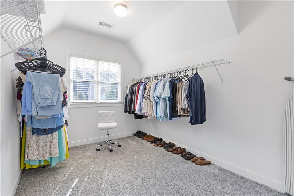 4867 Hunters Grove Way Sugar Hill, GA 30518 - Photo 36 of 61 a view of walk in closet with clothes and shoes