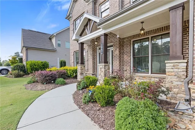 front view of a brick house with a yard