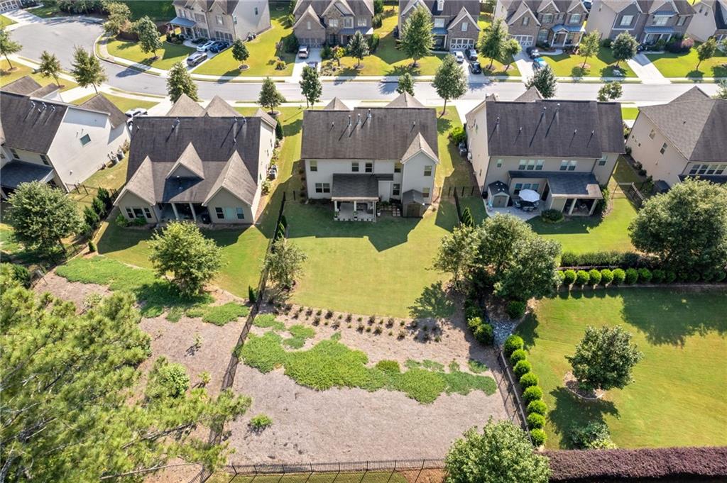 4867 Hunters Grove Way Sugar Hill, GA 30518 - Photo 60 of 61 an aerial view of house with swimming pool and outdoor space