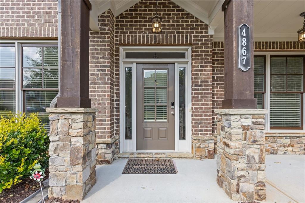 4867 Hunters Grove Way Sugar Hill, GA 30518 - Photo 7 of 61 a front view of a house with large windows