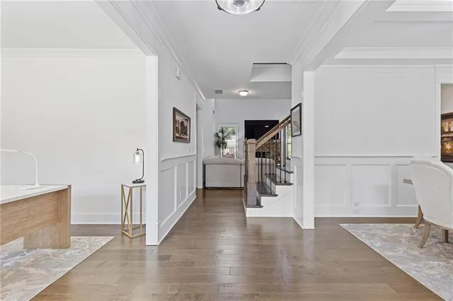 a view of an entryway with wooden floor and windows