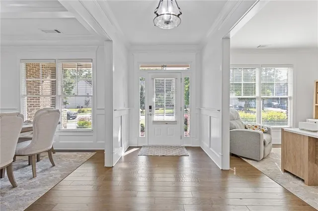 a living room with furniture windows and a dining table