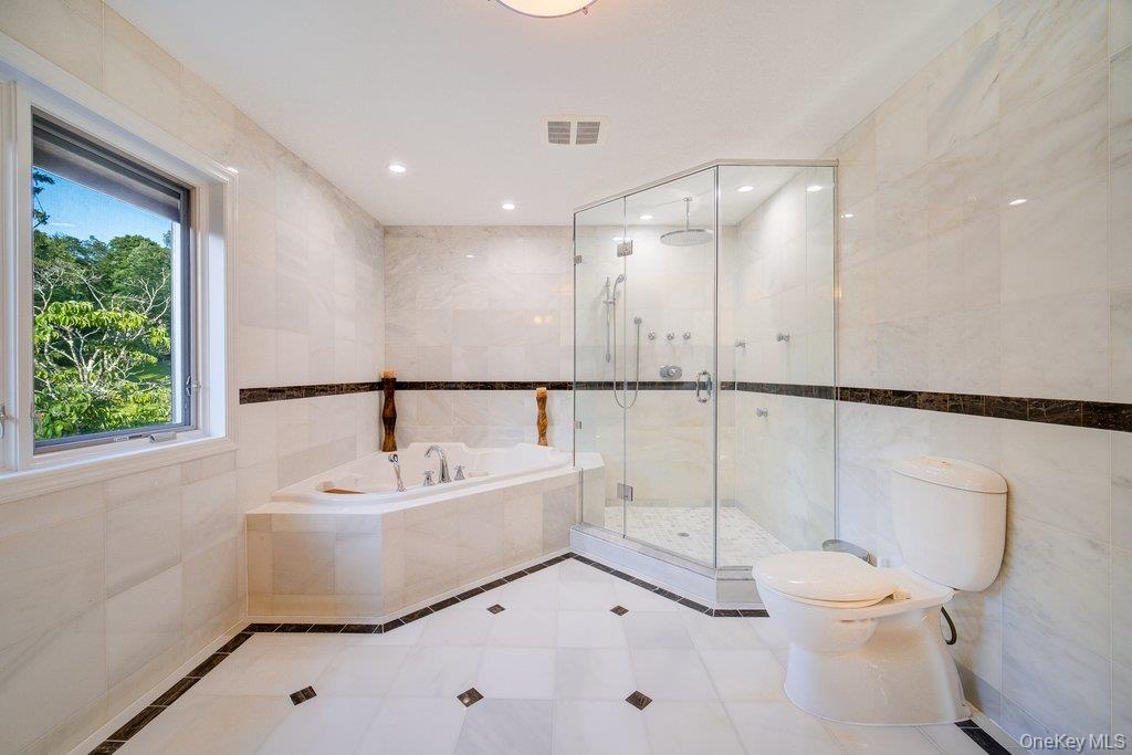 237 Mineral Springs Road Highland Mills, NY 10930 - Photo 24 of 32 Bathroom featuring tile walls, a bath, a shower stall, tile patterned flooring, and recessed lighting