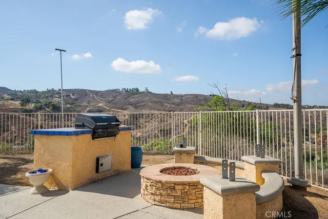 an aerial view of residential house with parking and trees