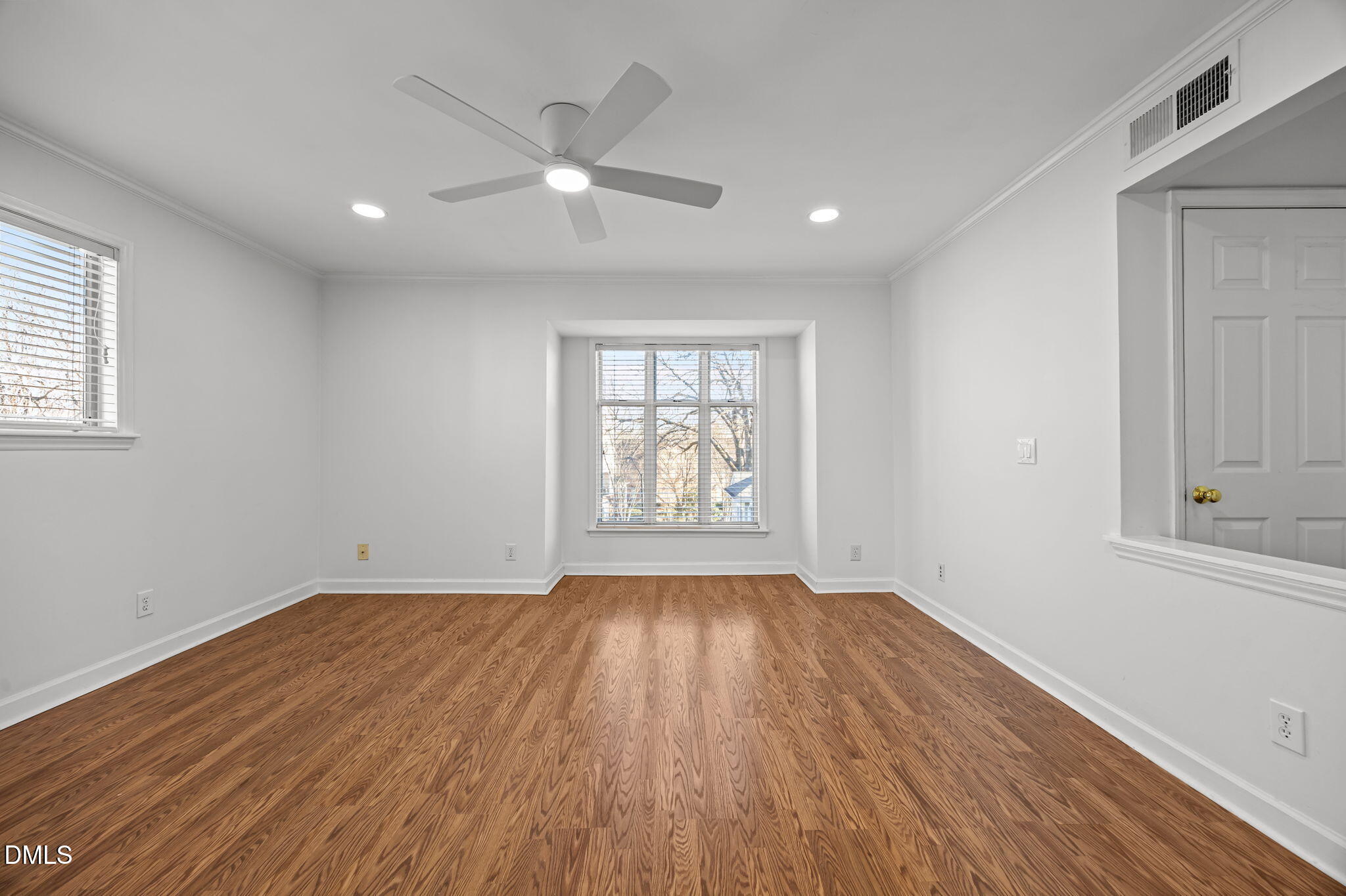 1210 Westview Lane, Unit 309 Raleigh, NC 27605 - Photo 8 of 42 a view of an empty room with wooden floor and a window