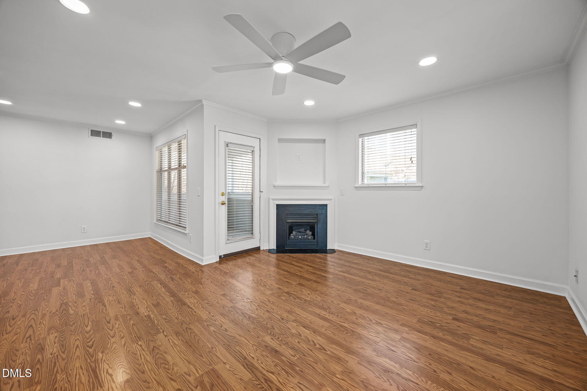 1210 Westview Lane, Unit 309 Raleigh, NC 27605 - Photo 9 of 42 a view of a livingroom with a fireplace a ceiling fan and windows