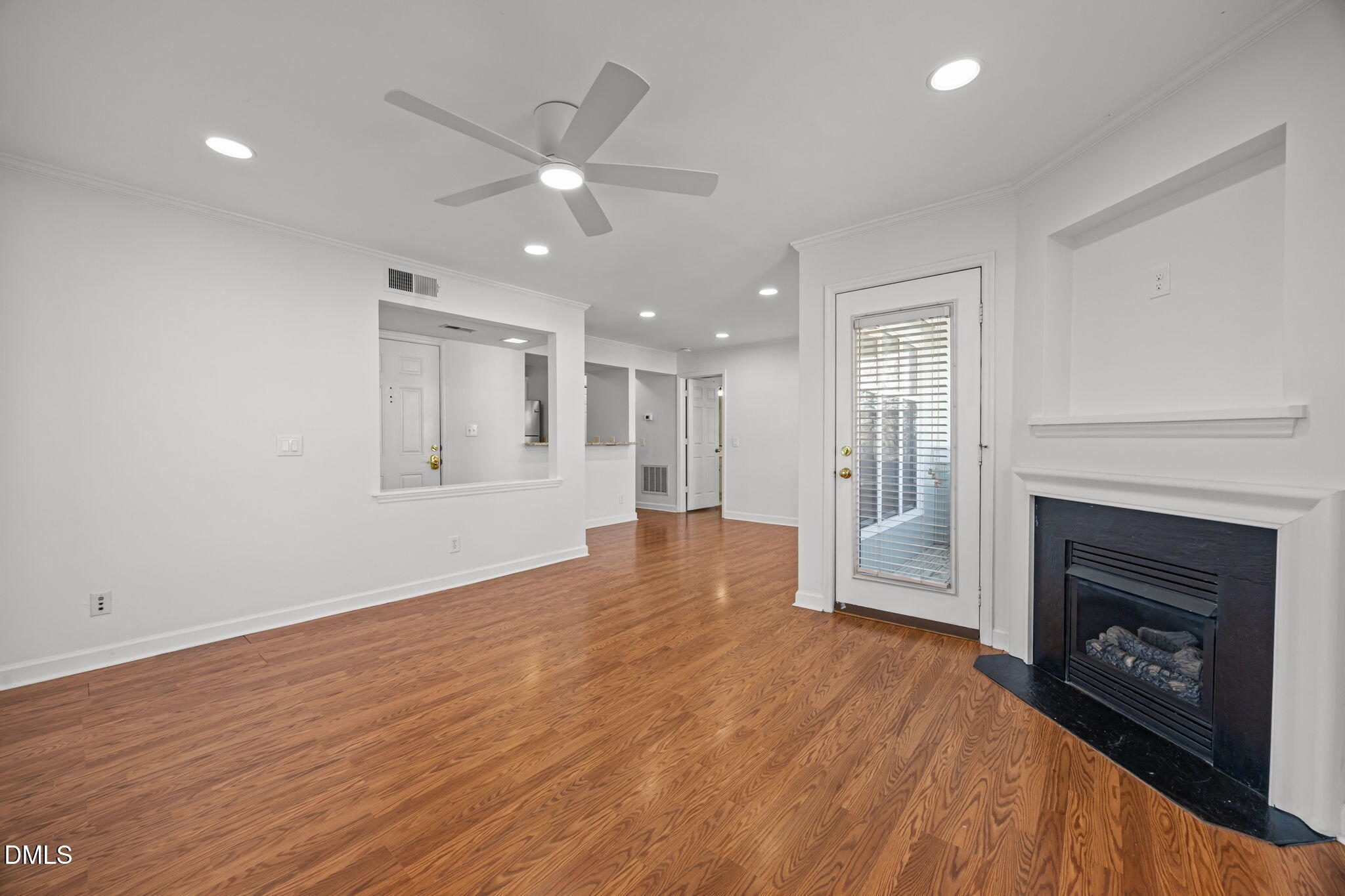 1210 Westview Lane, Unit 309 Raleigh, NC 27605 - Photo 10 of 42 an empty room with wooden floor fireplace and windows