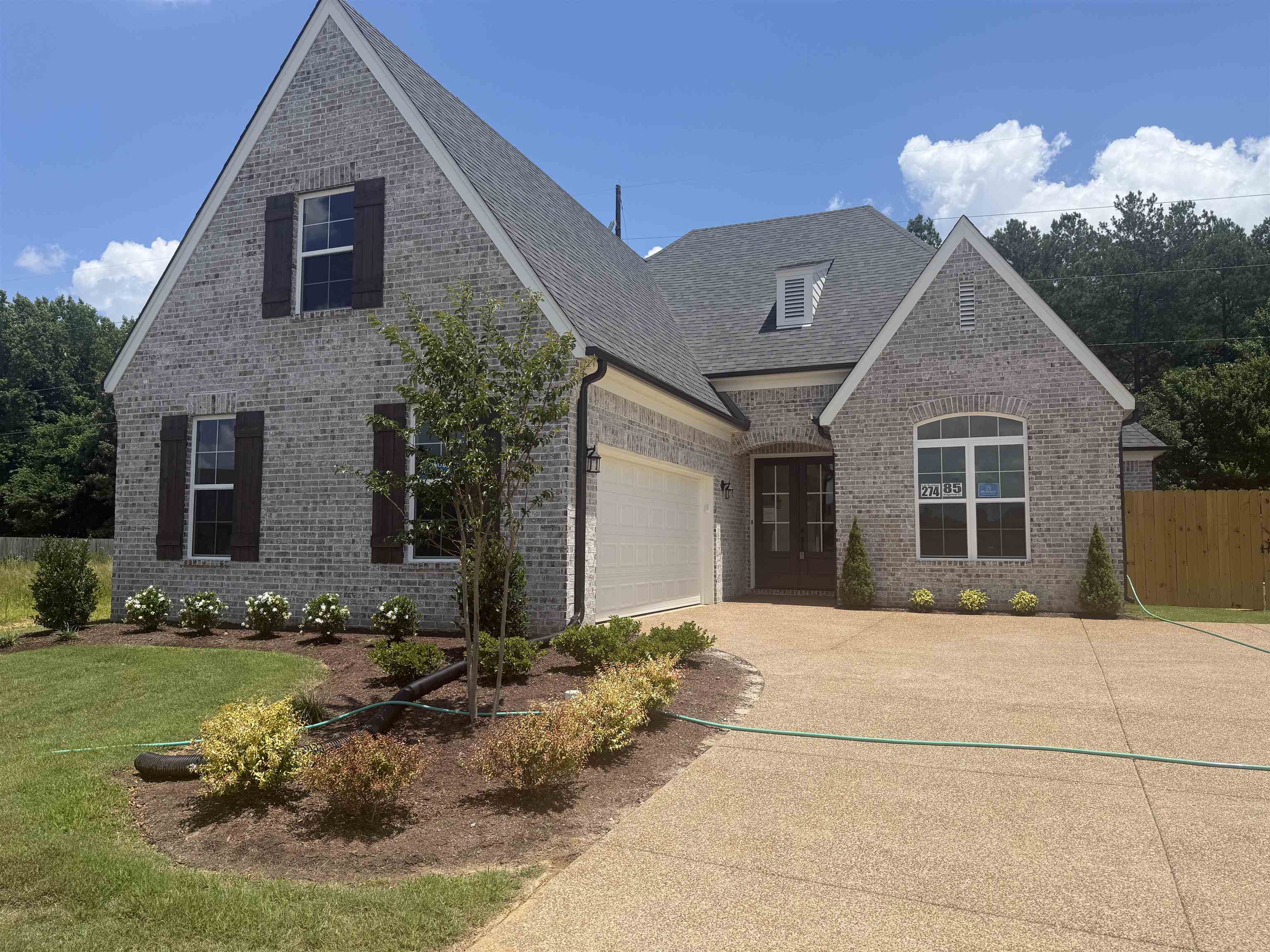 85 Ridgefield Drive Oakland, TN 38060 - Photo 1 of 12 a front view of a house with a yard and garage