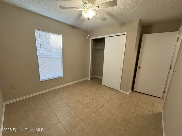 an empty room with windows and closet
