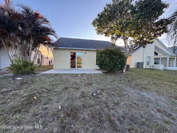 a house that has a tree in front of the house