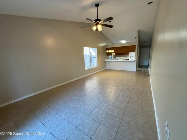 a view of a livingroom with a ceiling fan and window
