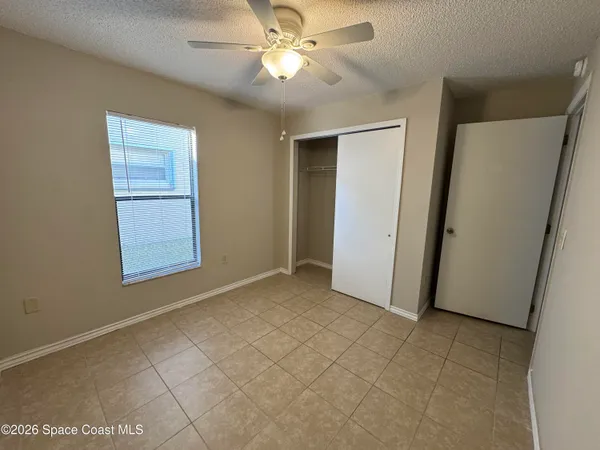 a view of an empty room and closet area
