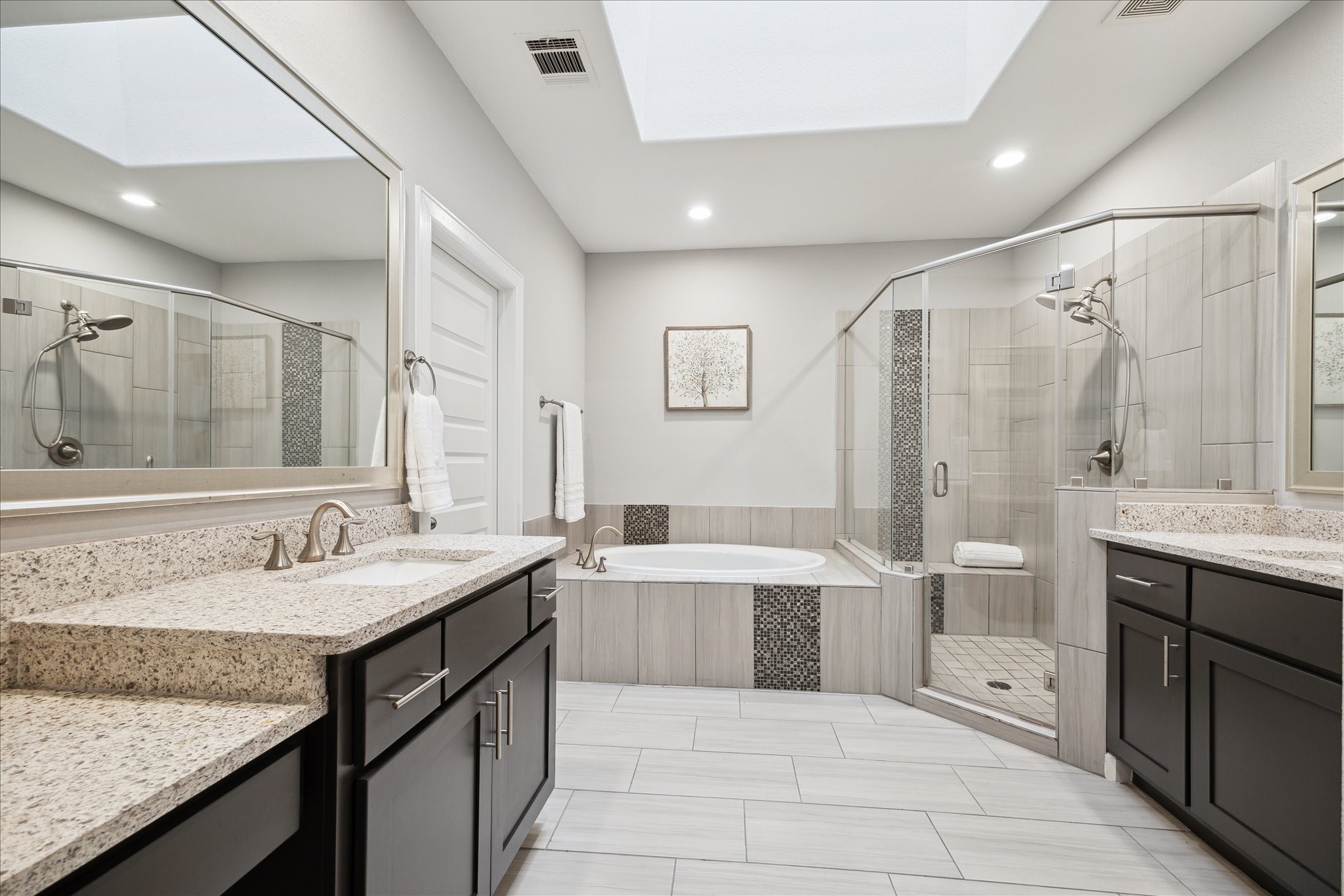 2430 Sheridan Street Houston, TX 77030 - Photo 15 of 28 a spacious bathroom with a granite countertop sink a toilet a mirror and shower