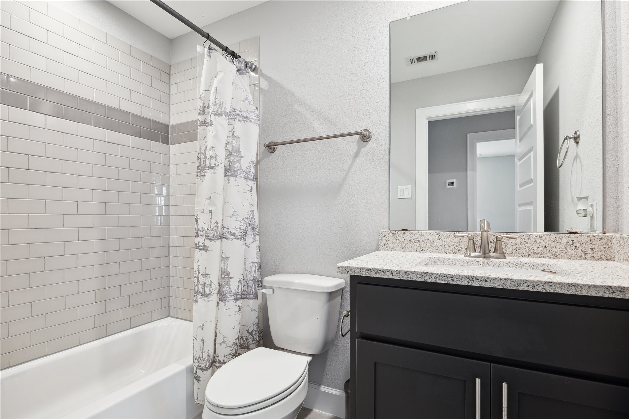 2430 Sheridan Street Houston, TX 77030 - Photo 19 of 28 a bathroom with a granite countertop sink toilet a mirror and shower
