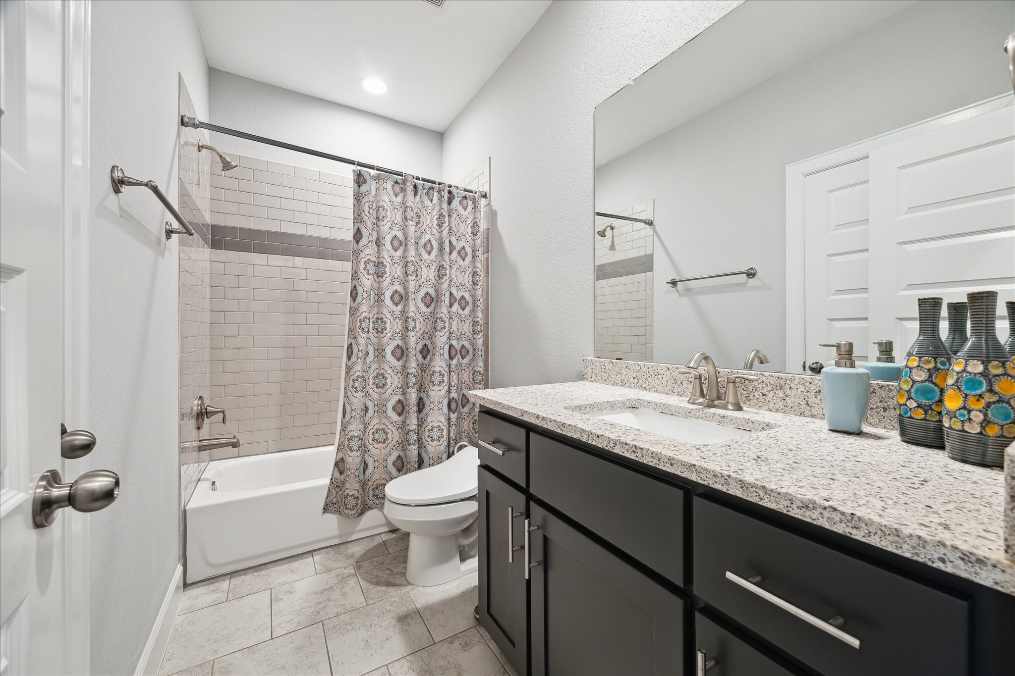 2430 Sheridan Street Houston, TX 77030 - Photo 24 of 28 a bathroom with a granite countertop sink a toilet and shower