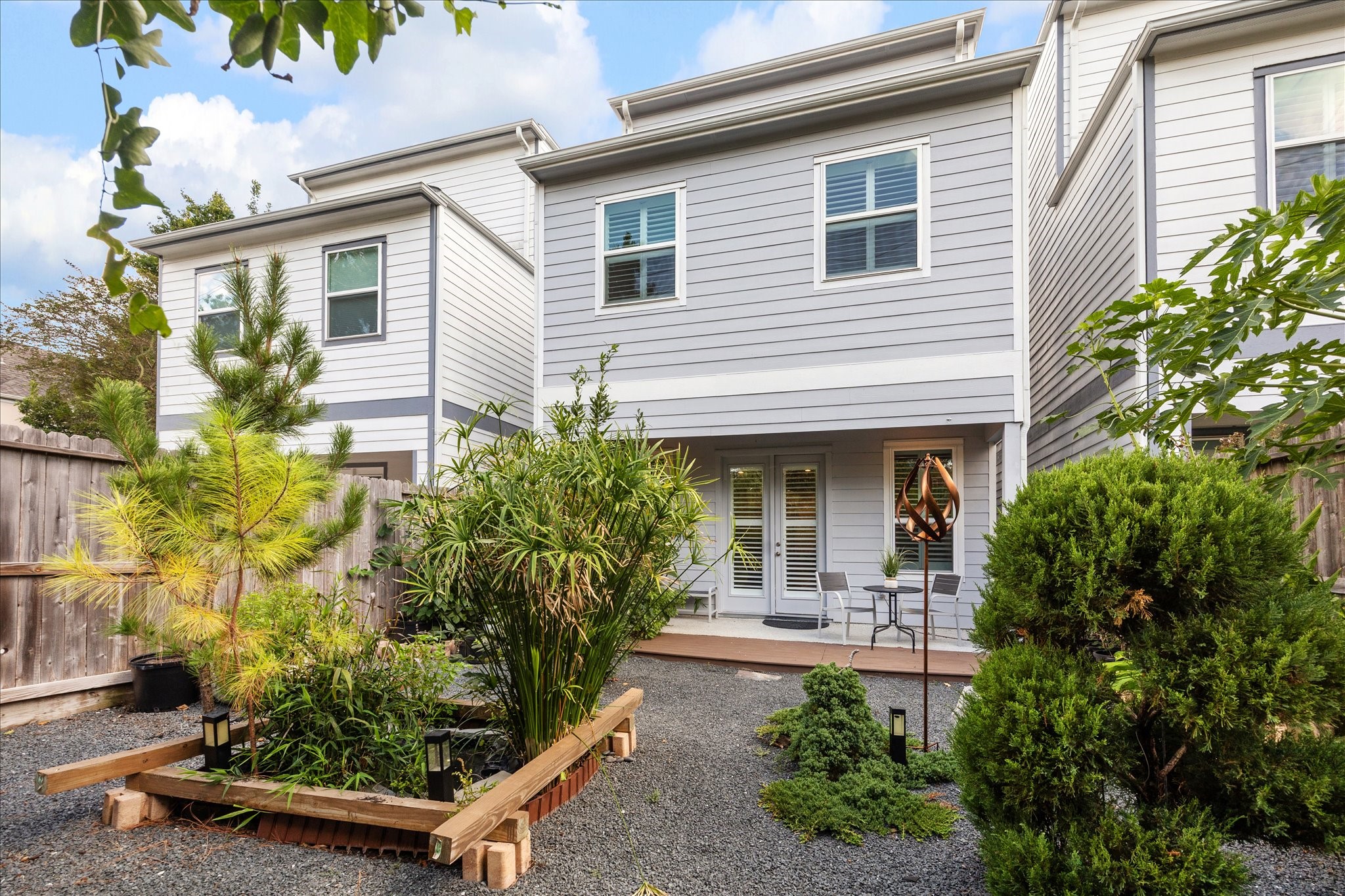 2430 Sheridan Street Houston, TX 77030 - Photo 28 of 28 a view of a house with potted plants and a bench